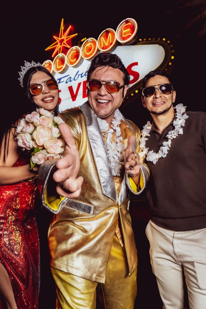 Couple renewing vows with Elvis at the Welcome to Fabulous Las Vegas sign during the day