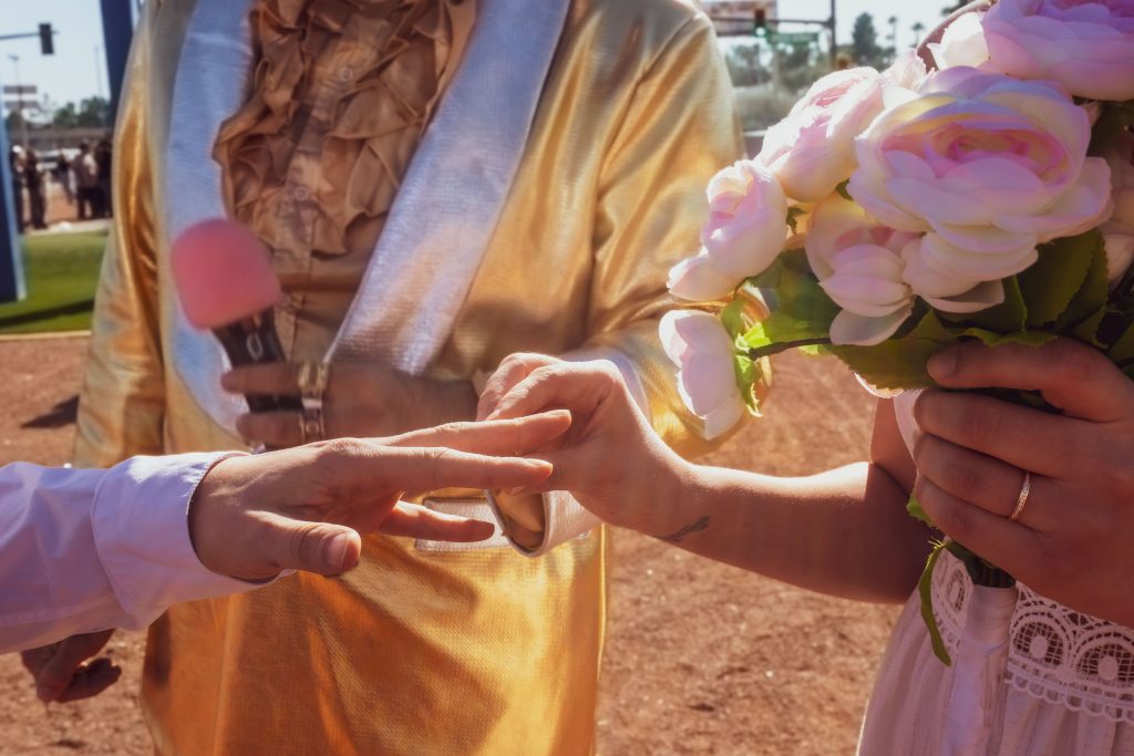 Close-up of ring exchange during Elvis vow renewal at the Las Vegas sign